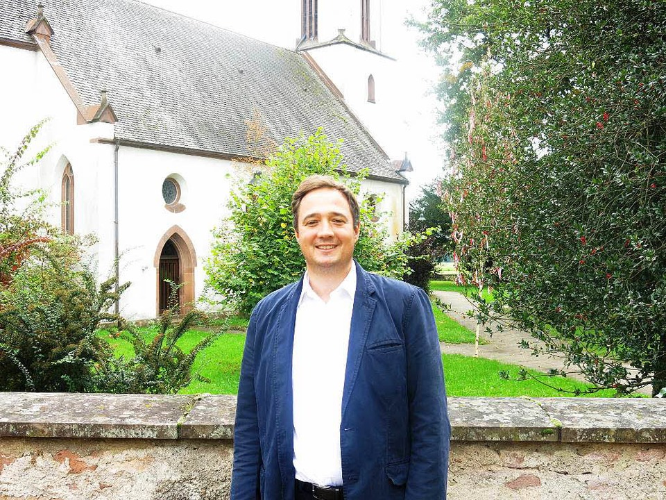 Gregor Herrmann, der neue Pfarrer der ...hengemeinde Sexau, vor der Dorfkirche.  | Foto: Georg Voß