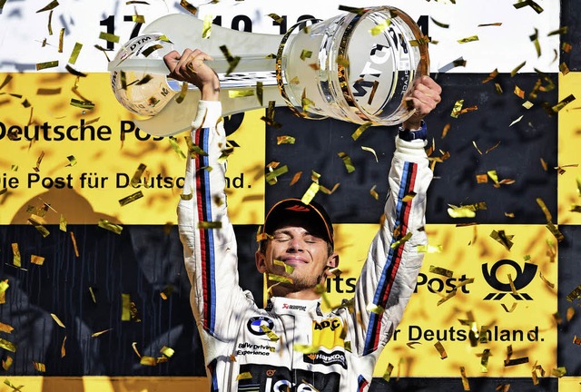 Konfetti fr den Besten: Marco Wittman...sich den Fahrertitel bei der DTM 2014.  | Foto: dpa