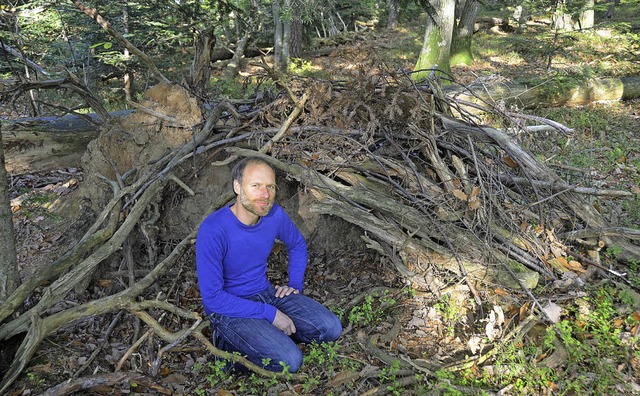Henning Herrenleben in einer Wurzelhhle im Wald   | Foto: Julia Trauden