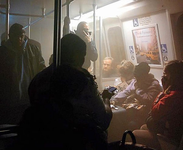 U-Bahn-Passagiere versuchen, sich vor dem Rauch zu schtzen.   | Foto: dpa