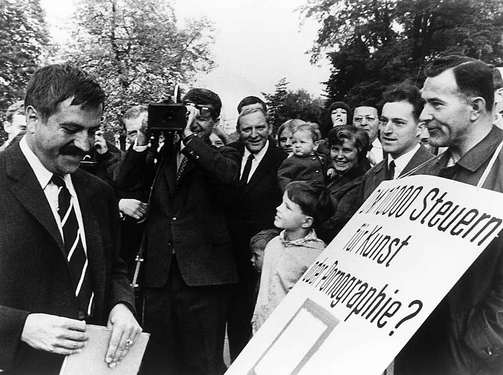 Der Schriftsteller Gnter Grass (l) unterhlt sich am 09.10.1965 in Darmstadt mit Demonstranten, die gegen die angebliche Unmoral in seinen Werken protestieren.