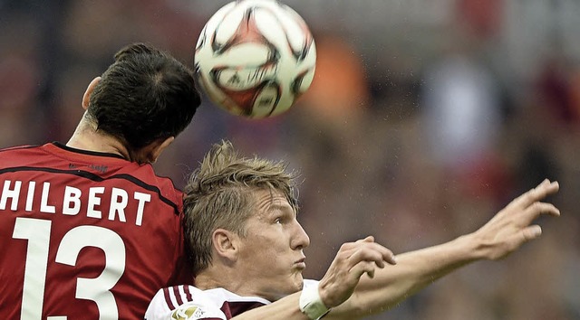 Da fehlen ein paar Zentimeter: Der Mn...m Kopfballduell mit  Roberto Hilbert.   | Foto: DPA