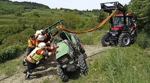 Die Einsatzkrfte beim Aufrichten des ... Bschung in Btzingen umgekippt ist.   | Foto: Patrick Kerber