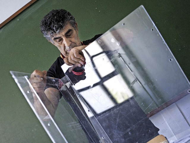 Ein Gemeindemitarbeiter baut in Athen eine Wahlurne fr das Referendum auf.   | Foto: DPA