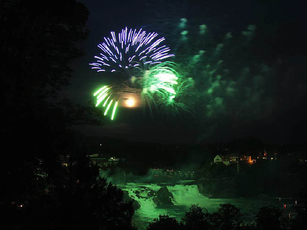Hans Rosemann: Das Foto (unbearbeitet) wurde  letzten Freitag beim Feuerwerk am Rheinfall in Schaffhausen aufgenommen. Als Besonderheit ist der zweite Vollmond (Bluemoon) im Monat Juli im Feuerwerk zu sehen.