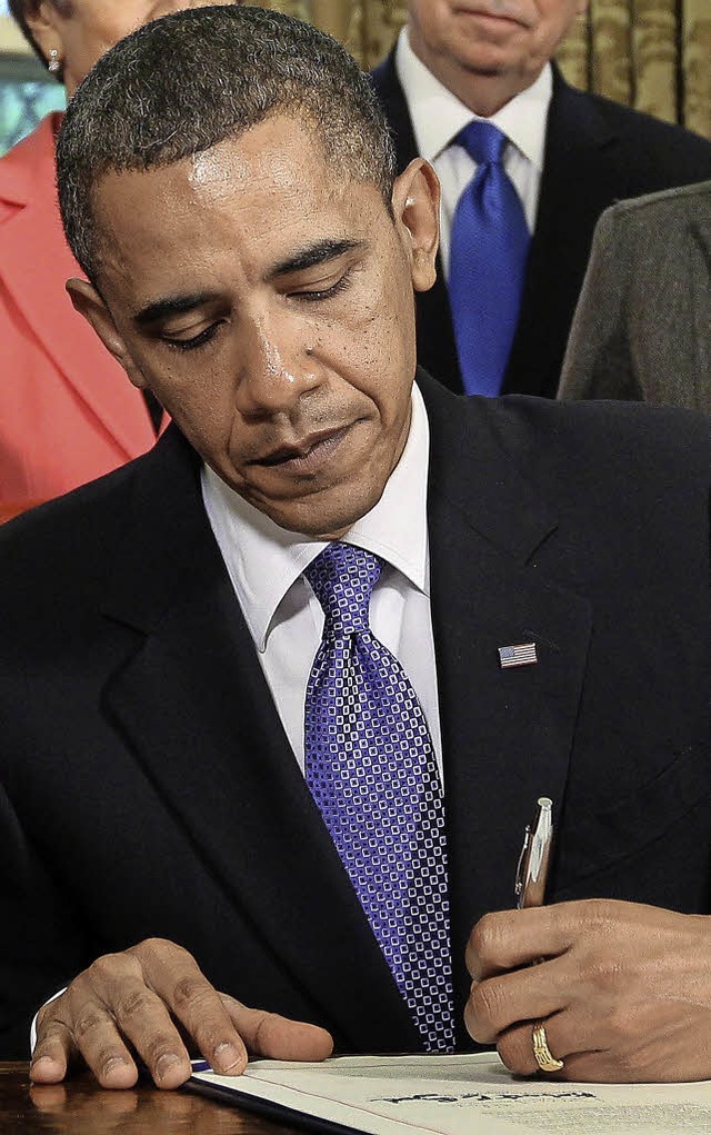 Fr manche ist er des Teufels: Linkshnder Barack Obama   | Foto: dpa