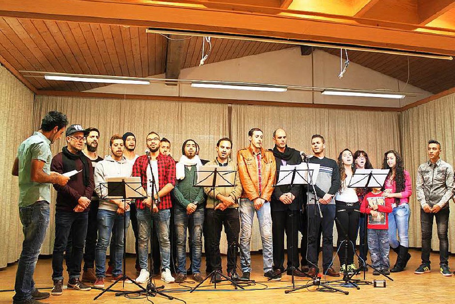 Ein ad hoc Chor aus Bewohnern des Asylantenheimes in der Schweizerstraße, solchen, die bereits Asyl bewilligt bekamen und Helfern des Asylkreises sang syrische Lieder und den Eurovisionschlager „Ein bisschen Frieden“. (Foto: Martha Weishaar) Ein ad hoc Chor aus Bewohnern des Asylantenheimes in der Schweizerstraße, solchen, die bereits Asyl bewilligt bekamen und Helfern des Asylkreises sang syrische Lieder und den Eurovisionschlager „Ein bisschen Frieden“. (Foto: Martha Weishaar)