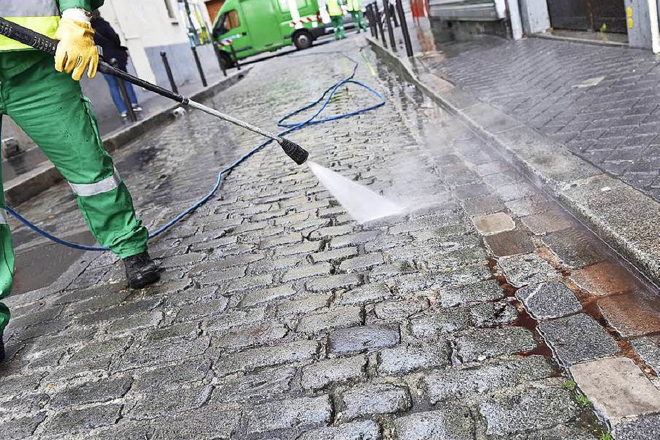 Ein Straßenreiniger entfernt Blut auf der Rue de Charonne. (Foto: AFP) Ein Straßenreiniger entfernt Blut auf der Rue de Charonne. (Foto: AFP)
