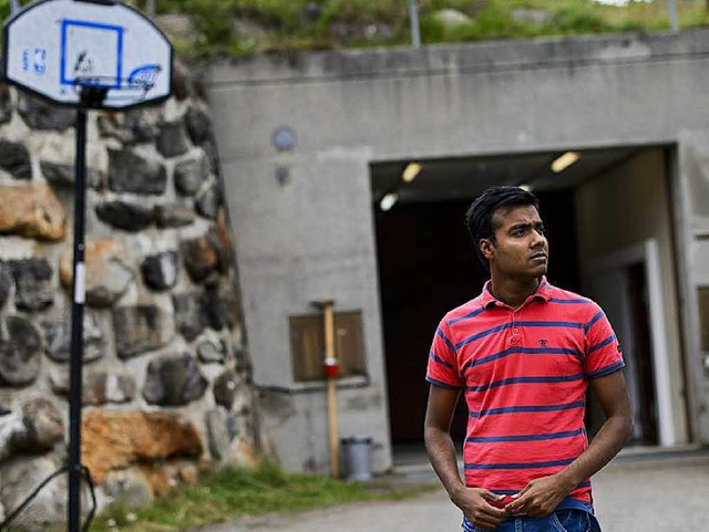 Ein Asylbewerber steht im August vor einem militrischen Bunker in Realp.  | Foto: afp