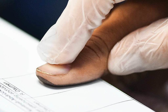 Ein Flchtling gibt bei seiner Registr...n Heidelberg seinen Fingerabdruck ab.   | Foto: dpa