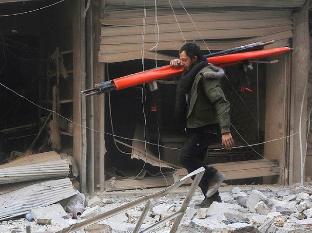 Nach einem Luftangriff syrischer Regie...vor einem zerstrten Gebude in Aleppo  | Foto: AFP