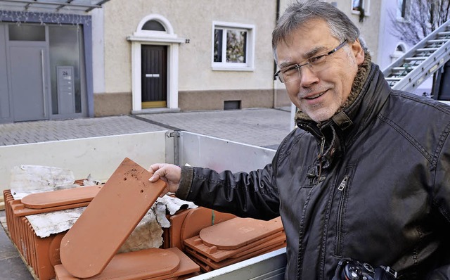 Pfarrer Joachim Kruse sieht sich die neuen Dachziegel an.  | Foto: Peter Gerigk