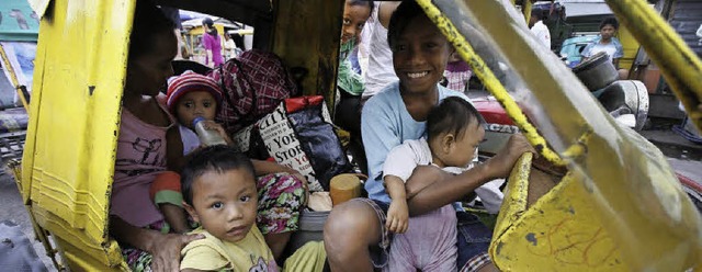 Zusammen unterwegs: eine Familie in Manila   | Foto: dpa