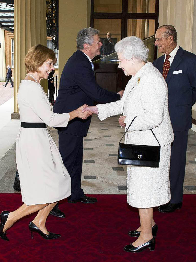 Daniela Schadt (l), Lebensgefhrtin von JoachimGauck, macht bei der Begrung vor Knigin Elizabeth II. am 13.11.2012 einen Knicks.