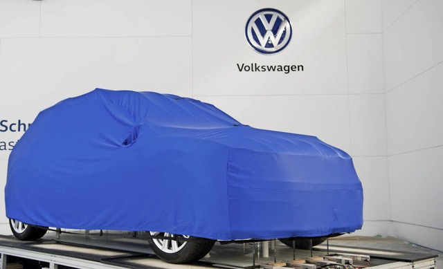 Ein verhlltes Auto steht am Stand von...swagen beim Aufbau der Hannover Messe   | Foto: dpa