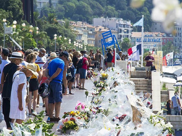 Menschen gedenken der 84 Opfer des Nizza-Attentats an der Strandpromenade.  | Foto: dpa