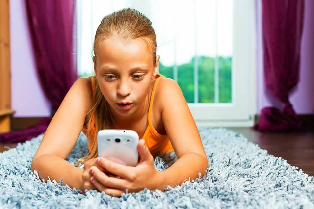 Ein Mdchen blickt auf ihr Smartphone....dass sie kurzsichtig wird, ist erhht.  | Foto: Colourbox.de