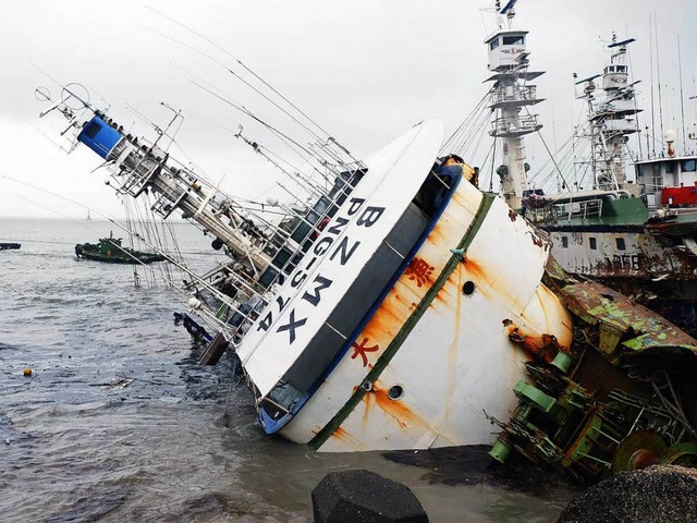 Der Taifun hat ein Fischerboot umgeworfen und gegen die Kste gepeitscht.   | Foto: AFP