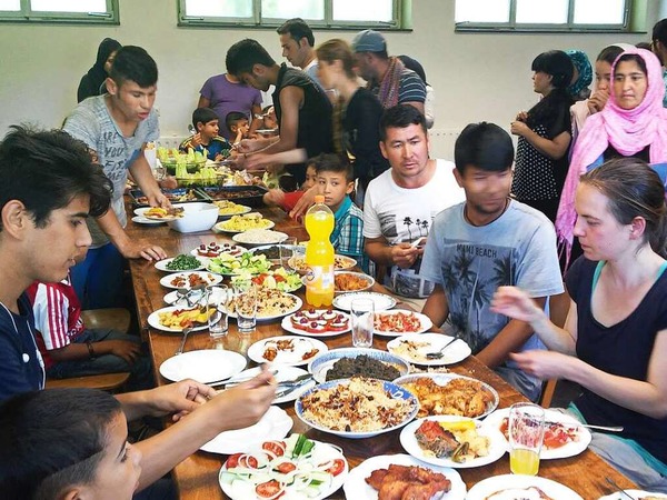 Harald Senn: Flchtlinge aus der Gemeinschaftsunterkunft Brchau zusammen mit Einheimischen beim gemeinsamen  Abendessen nach einem  Arbeitseinsatz am "Sagenweg".