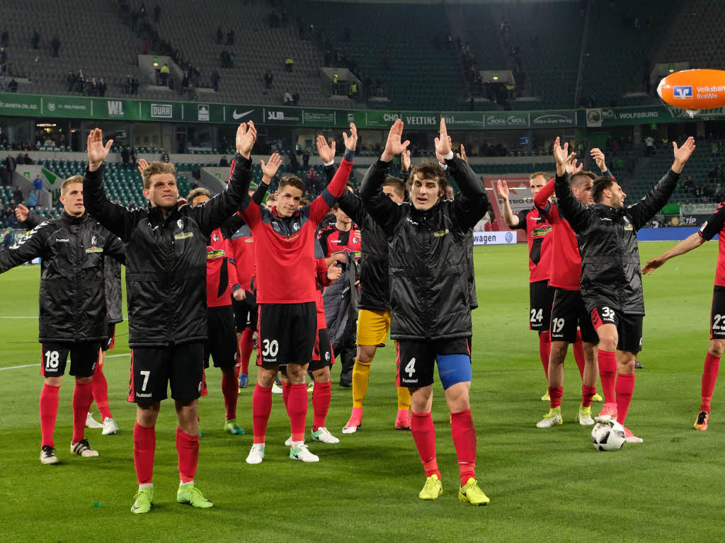 Freiburgs Spieler feiern mit ihren weit mitgereisten Fans vor dem Gsteblock.