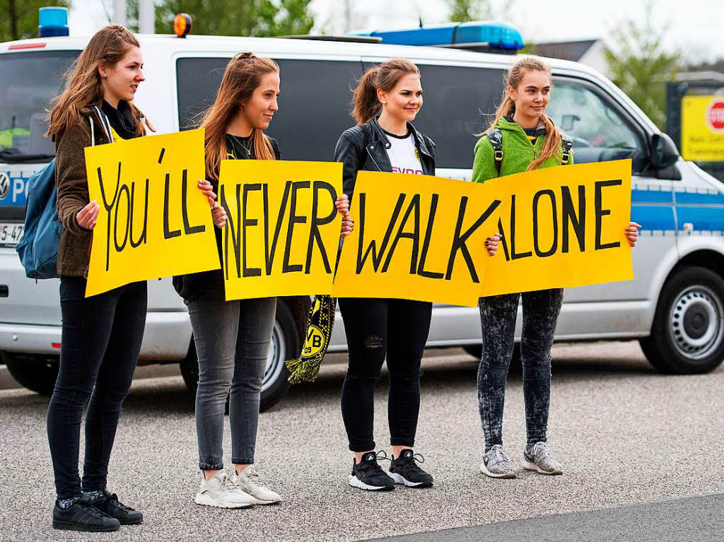 Fans halten vor dem Trainingsgelnde Schilder mit der Aufschrift „You'll never walk alone„.