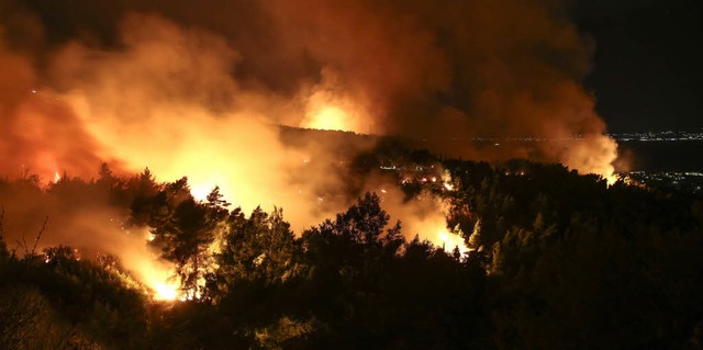 Flammen und Rauch steigen bei einem Waldbrand nahe Kalamos in Griechenland auf.   | Foto: dpa