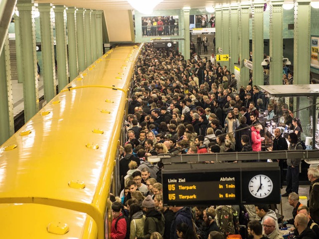 Reisende stehen in Berlin am U-Bahnhof Alexander Platz.  | Foto: dpa