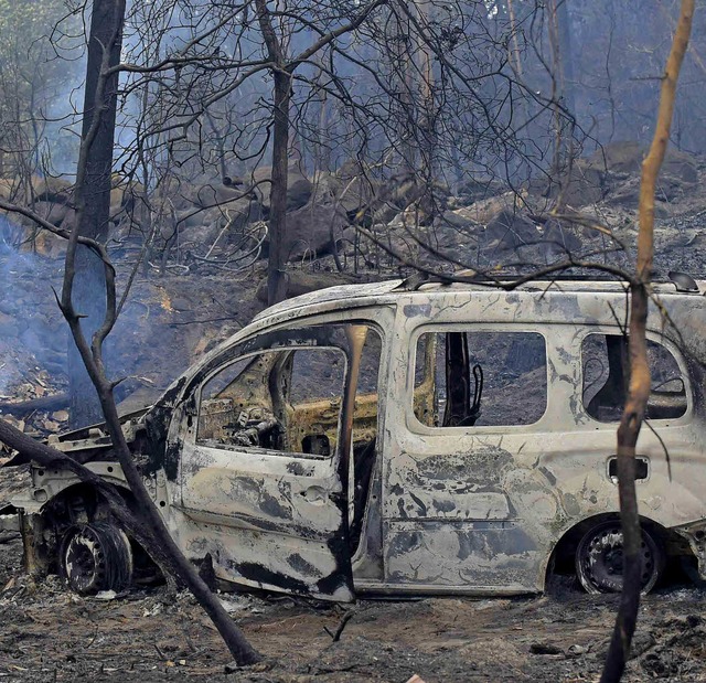 Zwei Menschen starben in diesem ausgebrannten Auto.   | Foto: AFP