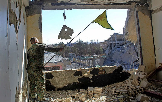 Das von dem kurdisch gefhrten Bndnis...Rakka eine kurdische Flagge schwenkt.   | Foto: dpa