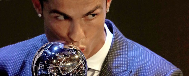 Cristiano Ronaldo knutscht seine neue Kugel.  | Foto: dpa