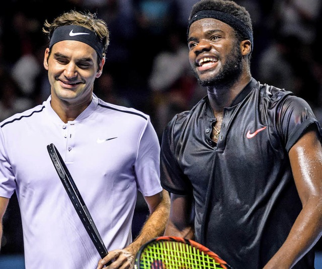 Roger Federer (links) und seine Erstrundengegner Frances Tiafoe  | Foto: afp