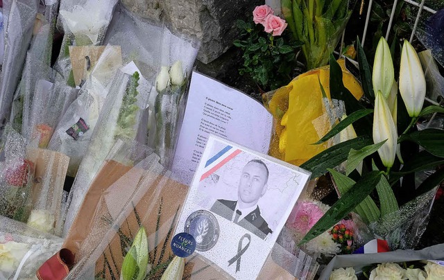 Menschen legen in Carcassonne  Blumen ...den Gendarmen Arnaud Beltrame nieder.   | Foto: AFP