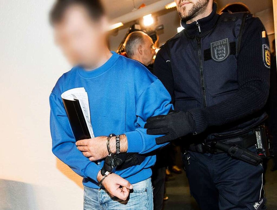 Ein Polizist bringt den Angeklagten Ca...urger Landgericht in den Gerichtssaal.  | Foto: dpa