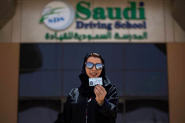 Reem, eine saudische Frau und Fahrlehr...er Fahrschule ihren Fhrerschein hoch.  | Foto: dpa