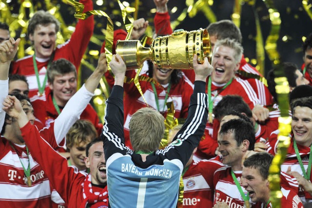 Bayerns Torwart Oliver Kahn prsentiert den DFB-Pokal.  | Foto: AFP