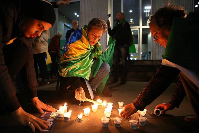 Nach der Messerattacke  znden Menschen Kerzen fr Jair Messias Bolsonaro an.   | Foto: DPA