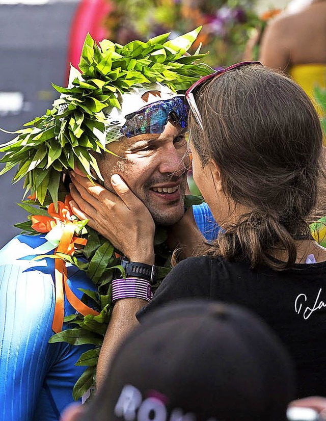 Patrick Lange macht mit Siegerkranz seiner Freundin einen Heiratsantrag.  | Foto: dpa