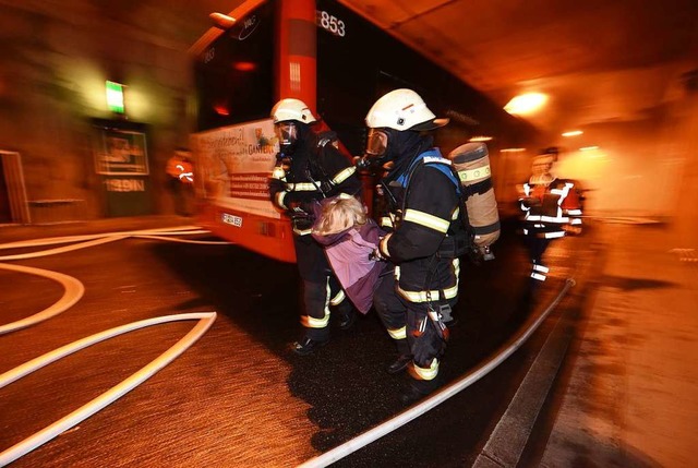 Feuerwehrleute tragen die  verletzten ...n in die  andere, sichere Tunnelrhre.  | Foto: Rita Eggstein