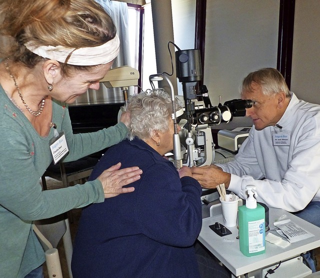 Augenarzt  Rainer Dnzen untersucht di...n Claudia Baer untersttzt ihn dabei.   | Foto: Claudia Bachmann-Goronzy