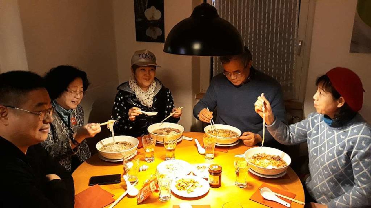 Eine Gruppe Chinesen isst  Pho-Suppe.  | Foto: Andreas Meinzer