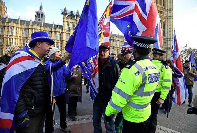 Pro- und Anti-Brexit-Demonstranten stehen vor dem Parlament in London.  | Foto: dpa