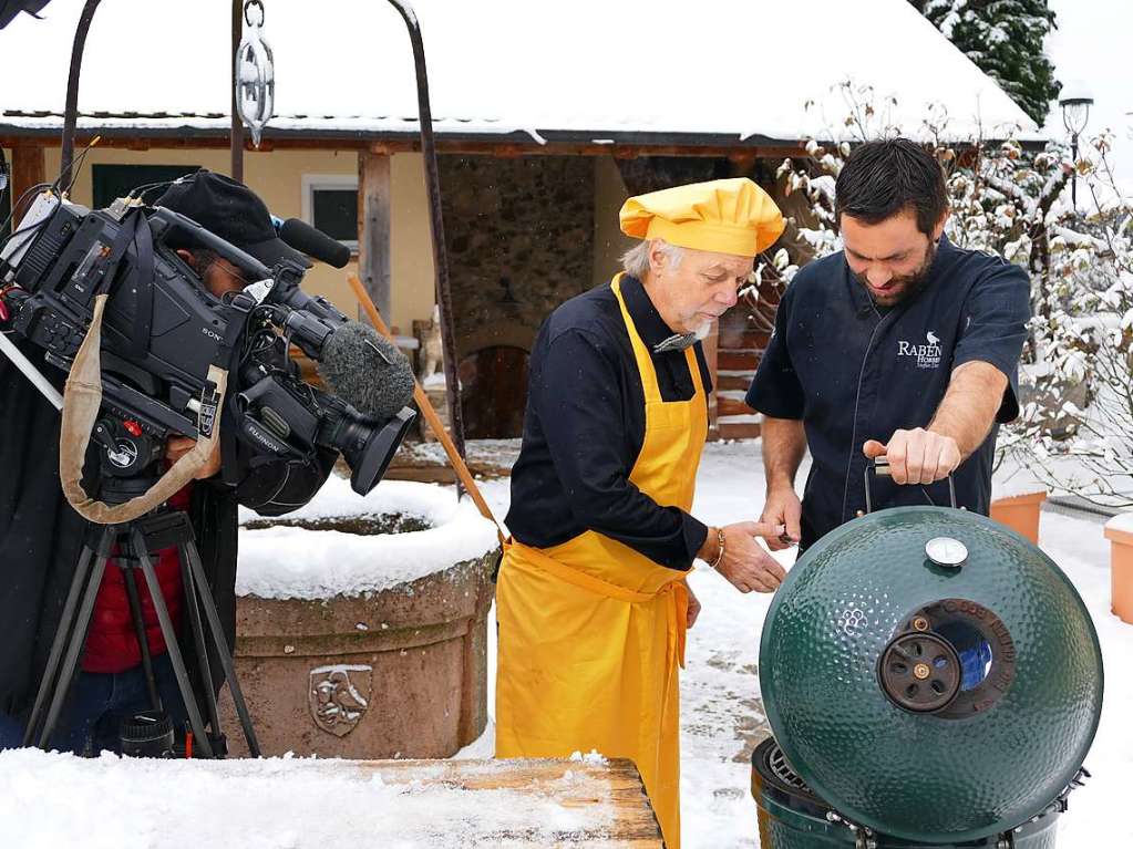 Schnee-Grillen: Steffen Disch zeigt dem franzsischen Journalisten Andr Muller (in gelb) die Sellerie auf dem Grill.