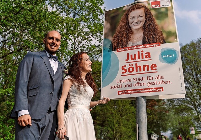 Julia Shne hngt im Hochzeitskleid ein Wahlplakat auf.  | Foto: Fioo Groe