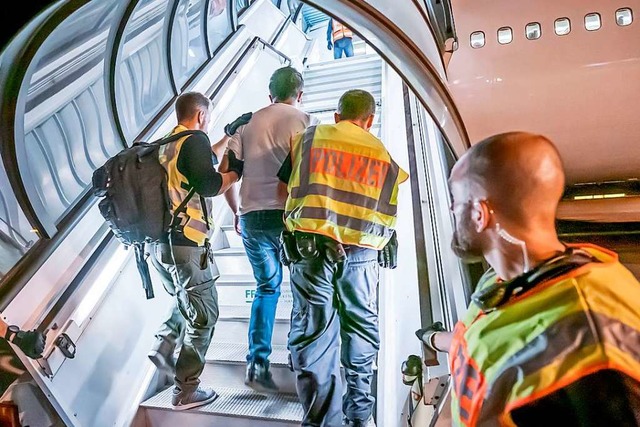 Polizeibeamte begleiten einen Afghanen... Leipzig-Halle in ein Charterflugzeug.  | Foto: Michael Kappeler