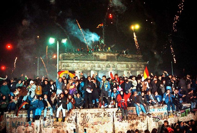 Silvester 1989: Ausgelassen feiern die Menschen auf der Berliner Mauer.  | Foto: Wolfgang Kumm