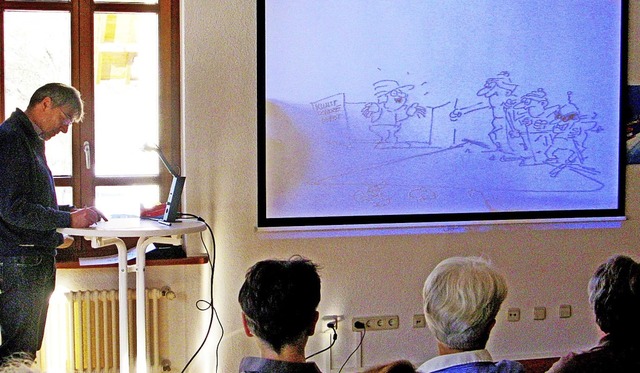 Thomas Zipfel zeichnete auf einem Pult... der drolligen Mnnchen mitverfolgen.   | Foto: Ulrike Spiegelhalter