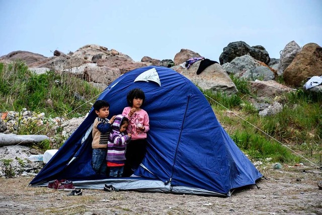 Kinder stehen vor einem Zelt im Dorf P...f der nordstlichen gisinsel Lesbos.  | Foto: Panagiotis Balaskas (dpa)