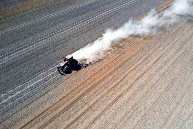 Staubtrocken: Ein Traktor fhrt ber ein Feld im Sdosten Polens.  | Foto: Darek Delmanowicz (dpa)