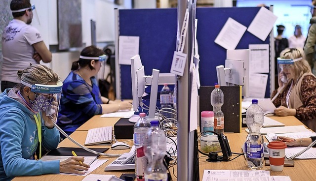 Mitarbeiter des Gesundheitsamtes Berli...mit Kontaktpersonen von Coronakranken.  | Foto: Britta Pedersen (dpa)