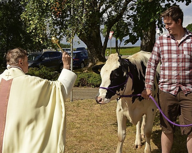 Pfarrer Ivan Hoyanic segnet die von Robin Vogelbacher gefhrte Kuh Annabell.   | Foto: Stefan Pichler